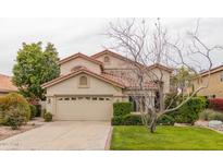 Two-story stucco home with a tile roof, a two car garage, and mature landscaping at 21614 N 59Th Ln, Glendale, AZ 85308