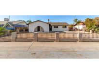 Charming single-story home featuring a secure fence and a well-maintained front yard at 2242 W Pecan Rd, Phoenix, AZ 85041