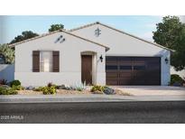 Charming single-story home with a modern facade, desert landscaping, and a two-car garage at 24486 W Grenadine Rd, Buckeye, AZ 85326