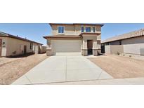 Charming two-story home with a wide driveway and a two-car garage in a residential neighborhood at 25130 N 156Th Ln, Surprise, AZ 85387