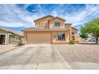 Charming two-story home with a well-maintained yard and attached two-car garage at 10308 E Osage Ave, Mesa, AZ 85212