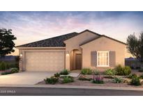 Charming single-story home featuring a two-car garage, neutral stucco finish, and professionally landscaped front yard at 17727 W Pueblo Ave, Goodyear, AZ 85338