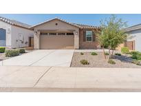 Charming single-story home featuring a desert landscape, a two-car garage, and a welcoming beige facade at 3264 W Caleb Rd, Phoenix, AZ 85083
