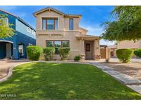 Charming two-story home featuring a well-manicured lawn and inviting curb appeal at 3443 E Jasper Dr, Gilbert, AZ 85296