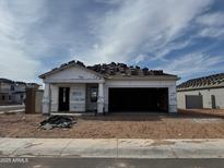 New construction home shows exposed framing, tile roof installation, and an attached two-car garage at 3850 E San Jose St, San Tan Valley, AZ 85143