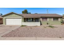 Charming single-story home featuring a desert landscape and a convenient two-car garage at 4004 W Myrtle Ave, Phoenix, AZ 85051