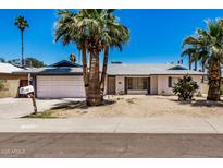 Charming single-story home with a two-car garage and desert landscaping at 4702 W Northview Ave, Glendale, AZ 85301