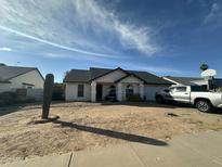 Charming single-story home featuring desert landscaping and a covered entryway at 4928 E Princess Dr, Mesa, AZ 85205