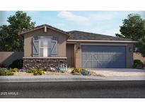 Charming single-story home featuring stone accents, gray shutters, and a two-car garage at 5525 S 246Th Ave, Buckeye, AZ 85326