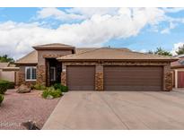 Charming single-story home featuring a three-car garage and desert landscaping at 5536 E Gable Ave, Mesa, AZ 85206