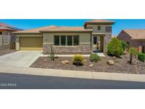Charming single-story home with desert landscaping, stone accents and a covered entryway at 6914 W Juana Dr, Peoria, AZ 85383