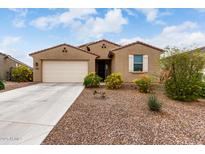 Charming single-story home featuring desert landscaping, a two-car garage, and a welcoming front entrance at 7216 N 124Th Ln, Glendale, AZ 85307