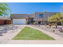 Charming home with manicured lawn, desert landscaping and a spacious two-car garage at 8307 E Buena Terra Way, Scottsdale, AZ 85250