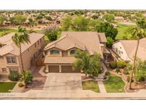 Two-story home featuring a tile roof, a manicured lawn, desert landscaping, and a two-car garage at 9708 E Pampa Ave, Mesa, AZ 85212