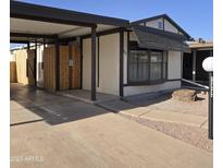 Cozy home featuring a carport, walkway, and low maintenance desert landscaping at 10951 N 91St Ave # 255, Peoria, AZ 85345