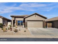 Charming single-story home featuring desert landscaping, a two-car garage and neutral exterior paint at 18434 E El Buho Pequeno Rd, Gold Canyon, AZ 85118