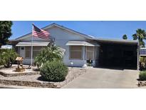 Charming single-story home with a covered carport and well-maintained front yard with desert landscaping at 2400 E Baseline Ave # 169, Apache Junction, AZ 85119