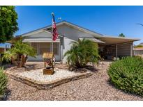 Charming single-story home with well maintained landscaping and a covered carport on a sunny day at 2400 E Baseline Ave # 169, Apache Junction, AZ 85119