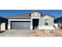 Charming single-story home featuring a well-manicured lawn, neutral paint scheme, and a two-car garage at 25484 W Graham Trl, Buckeye, AZ 85326