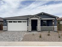 Charming single-story home featuring a two car garage and low maintenance desert landscaping at 40512 W Rio Grande Dr, Maricopa, AZ 85138