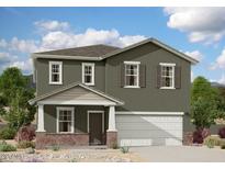 Charming two-story home with a covered porch and desert landscaping at 5826 W Sunrise Dr, Laveen, AZ 85339