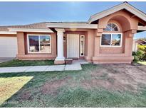 Charming single-story home featuring new windows, a decorative pillar and an arched window above the porch at 915 E Annette Dr, Phoenix, AZ 85022