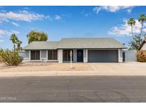 Charming single-story home featuring desert landscaping and a two-car garage at 1416 W Highland St, Chandler, AZ 85224
