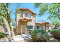 Charming two-story home with desert landscaping and a red tile roof under a clear blue sky at 17610 N 17Th Pl # 2, Phoenix, AZ 85022