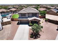 Two-story home featuring a well-maintained yard, a covered porch, and an attached two-car garage at 18351 W Southgate Ave, Goodyear, AZ 85338
