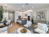 Bright living room featuring modern furnishings, an open floor plan, and a stylish kitchen with a center island at 1910 W Desert Hollow Dr, Phoenix, AZ 85085