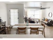 Bright dining area features a white table with seating, seamlessly connecting to the open-concept living space at 20 S Buena Vista Ave # 111, Gilbert, AZ 85296
