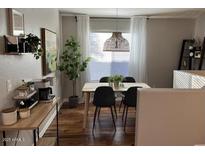 Bright dining room featuring a modern light fixture, dining set, and contemporary design elements at 2150 E Bell Rd # 1068, Phoenix, AZ 85022
