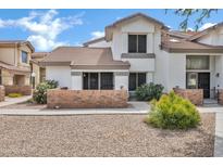 Charming townhome with a well-maintained exterior, beautiful landscape, and a brick wall at 2201 N Comanche Dr # 1093, Chandler, AZ 85224