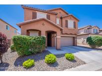 Charming two-story home featuring a two-car garage and well-maintained landscaping under a clear blue sky at 316 N 78Th Pl, Mesa, AZ 85207