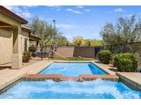 Inviting backyard pool and patio area offers a refreshing outdoor retreat at 32819 N 23Rd Ave, Phoenix, AZ 85085