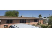 Cozy single-story home featuring a classic desert landscape and a white roof car at 337 N 85Th St, Mesa, AZ 85207