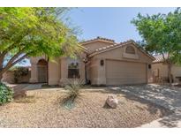 Charming single-story home featuring desert landscaping, a two-car garage, and a neutral stucco facade at 43803 W Wade Dr, Maricopa, AZ 85138