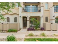 Charming two-story townhome featuring a welcoming front porch and upper-level balcony at 4637 S Jetty --, Mesa, AZ 85212