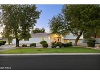 Charming single-Gathering home with a well-maintained front yard and mature shade trees at 5202 E Larkspur Dr, Scottsdale, AZ 85254