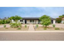Charming single-story home featuring a well-manicured front yard with desert landscaping and brick pathway leading to the front door at 5441 E Wethersfield Rd, Scottsdale, AZ 85254