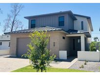 Modern two-story home featuring a brick facade, gray siding, and a well-manicured front yard at 5537 E Earll Dr, Phoenix, AZ 85018
