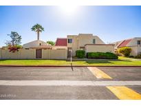 Charming townhome with a red roof, desert landscaping, and a palm tree in the front yard at 6004 N 79Th St, Scottsdale, AZ 85250