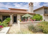 Charming single-story home with a red tile roof, front patio and desert landscaping at 6349 N 78Th St # 105, Scottsdale, AZ 85250