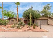 Charming desert landscaping enhances this single-story home with a two-car garage and red rock accents at 7210 N 17Th Ave, Phoenix, AZ 85021