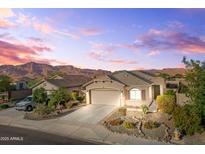 Charming single-story home with desert landscaping, mountain views, and an attached two-car garage at 7577 S Towel Creek Dr, Gold Canyon, AZ 85118