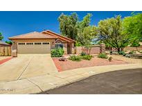 Charming single-story home featuring a tile roof, desert landscaping, and a two-car garage at 8178 W Tonopah Dr, Peoria, AZ 85382