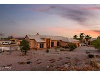 Inviting single-story home featuring a well-manicured front yard and neutral-toned exterior at sunset at 8351 S Summit Dr, Casa Grande, AZ 85193