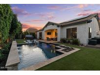 Inviting backyard with a sparkling pool, hot tub and outdoor seating area perfect for relaxing and entertaining at 883 E Hampton Ln, Gilbert, AZ 85295
