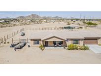 Charming single-story home featuring a well-maintained desert landscape and covered front porch at 8912 N Johnson Ct, Maricopa, AZ 85139