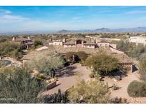Expansive desert home with stunning mountain views and lush desert landscaping at 10010 E Blue Sky Dr, Scottsdale, AZ 85262